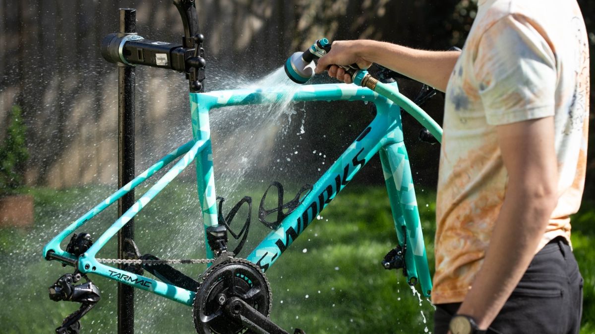 Soap being applied to dirty bicycle frame