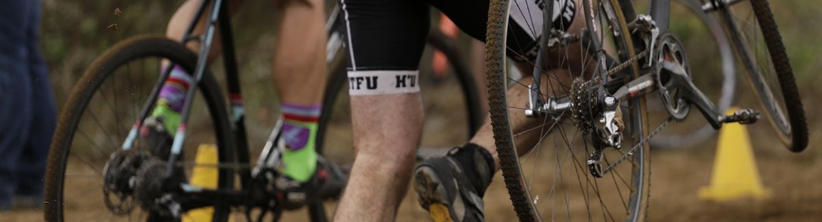 Cyclist jumping over cyclocross barrier