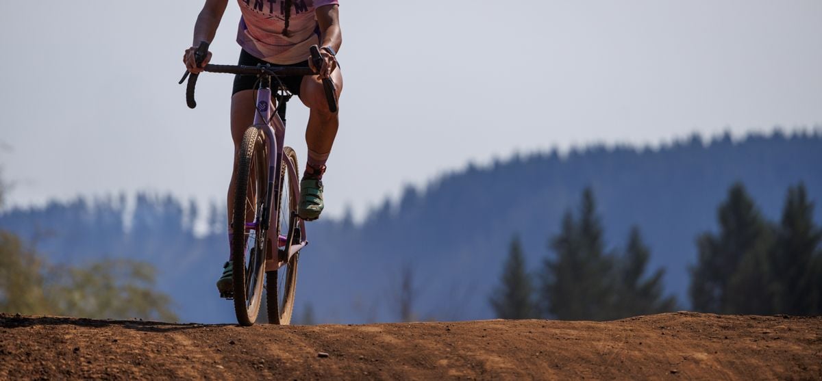 cyclocross with a forested hill in the background