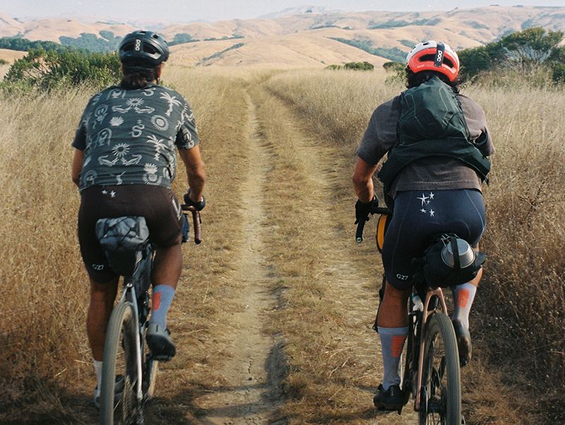 Two gravel riders with cycling bags