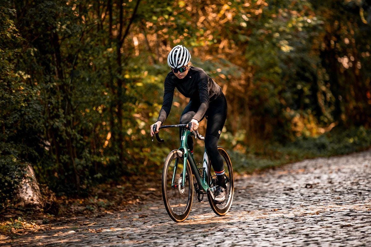 Cyclist riding on cobble road.